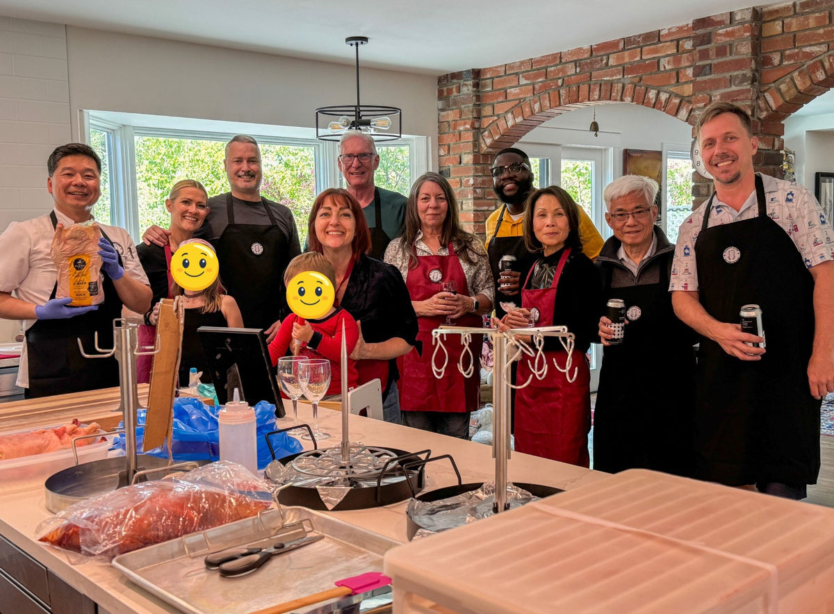 Participants gather around the UpRoaster and its attachments during a live cooking-class demonstration.